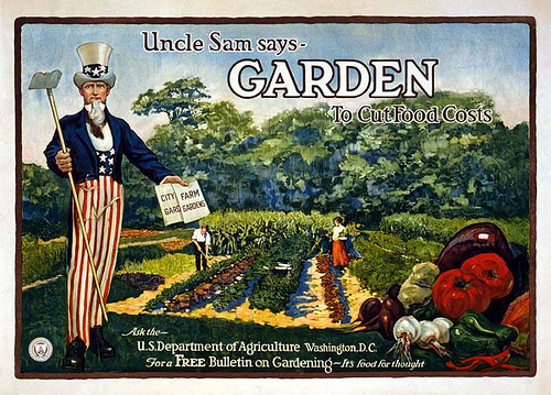 Uncle Sam says Garden to cut food costs green background of garden with a picure of Uncle Sam in Red White and Blue holding a garden hoe